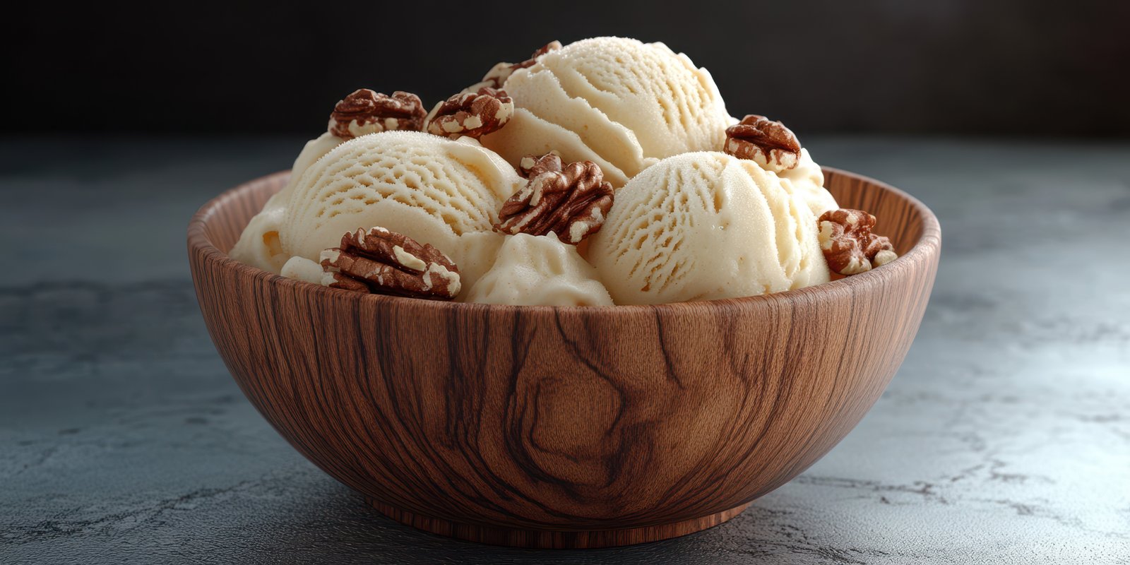 Delicious bowl of creamy vanilla ice cream topped with crunchy pecans